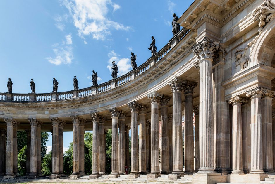 Elegant columned facade of Sanssouci Palace in Potsdam, showcasing historic Rococo architecture.