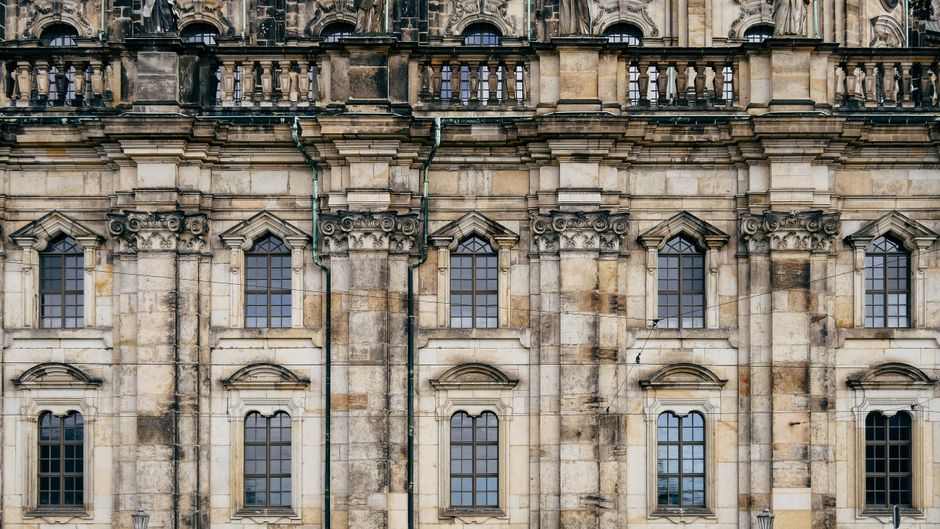 Close-up view of a gothic-style historic castle facade showcasing intricate stone architecture.