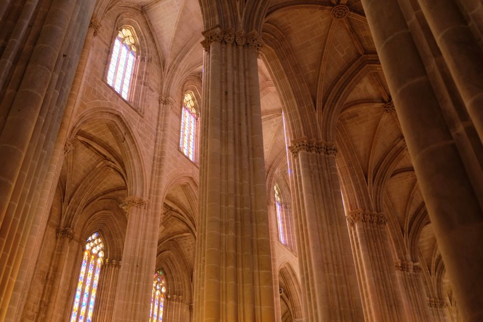 Stunning view of Gothic cathedral's intricate vaulted ceilings and stained glass windows.